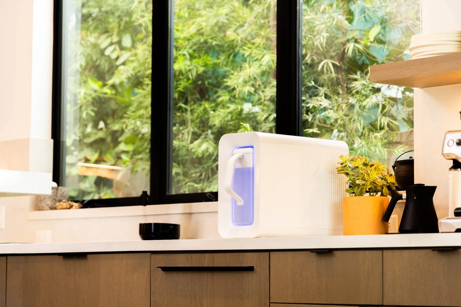 Pouring fresh water from the Spout Always Fresh Pitcher in a kitchen