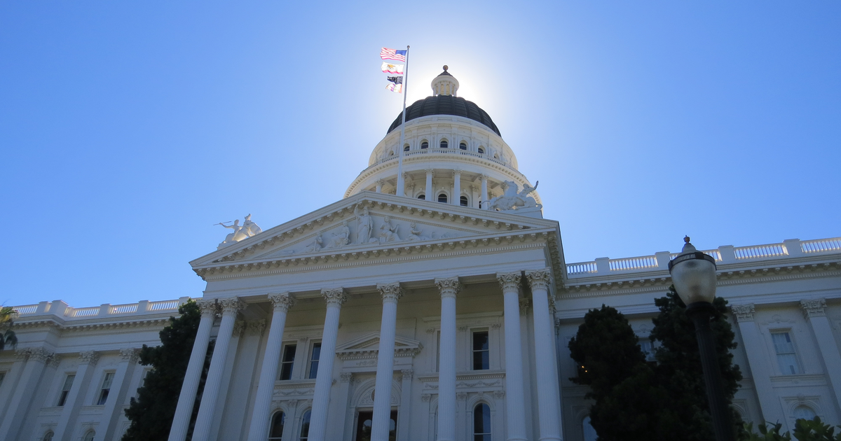 The California State Capitol dome in Sacramento under a clear sky.