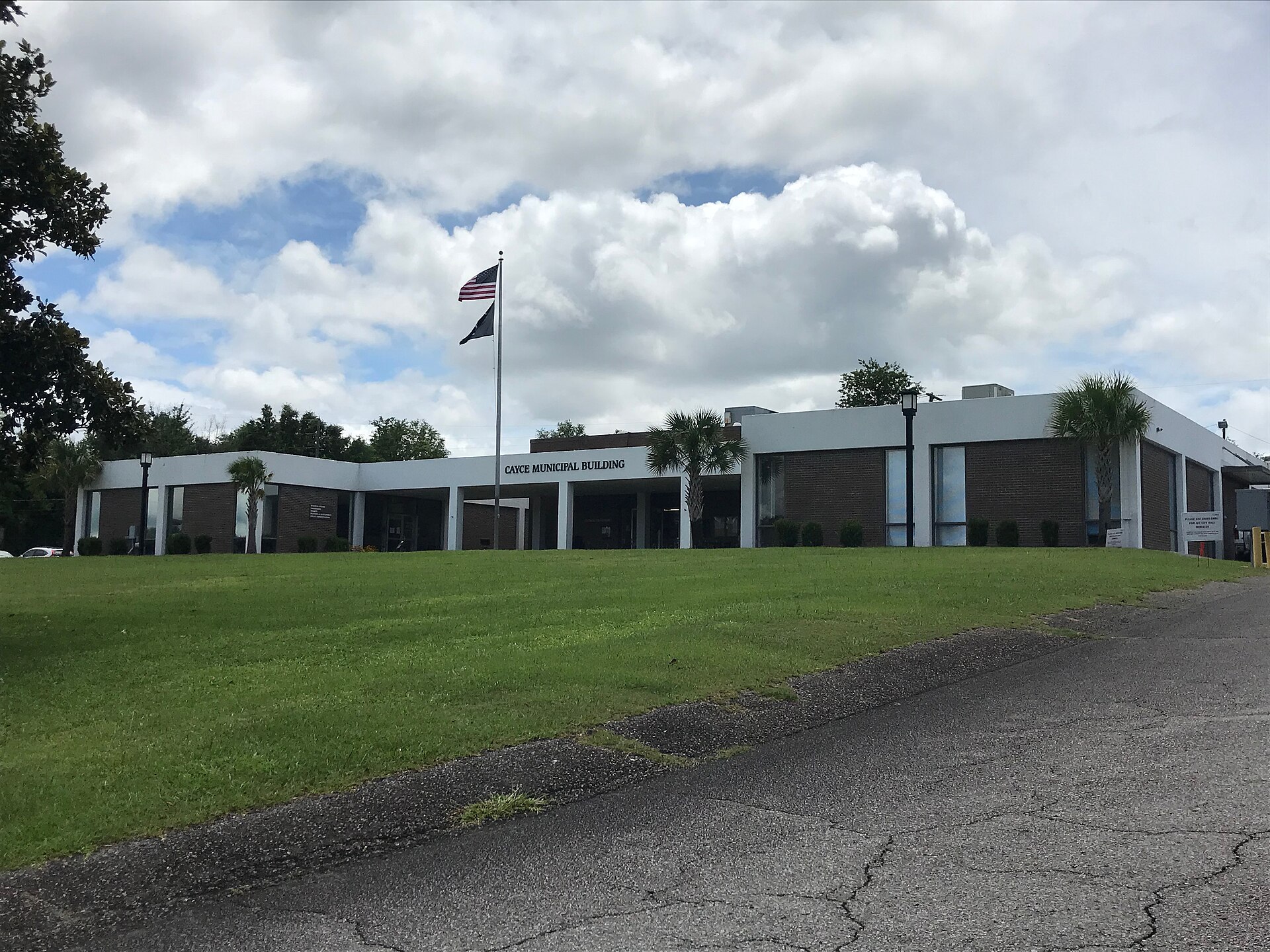 Cayce, S.C., City Hall, a low brick building with a flagpole and lawn