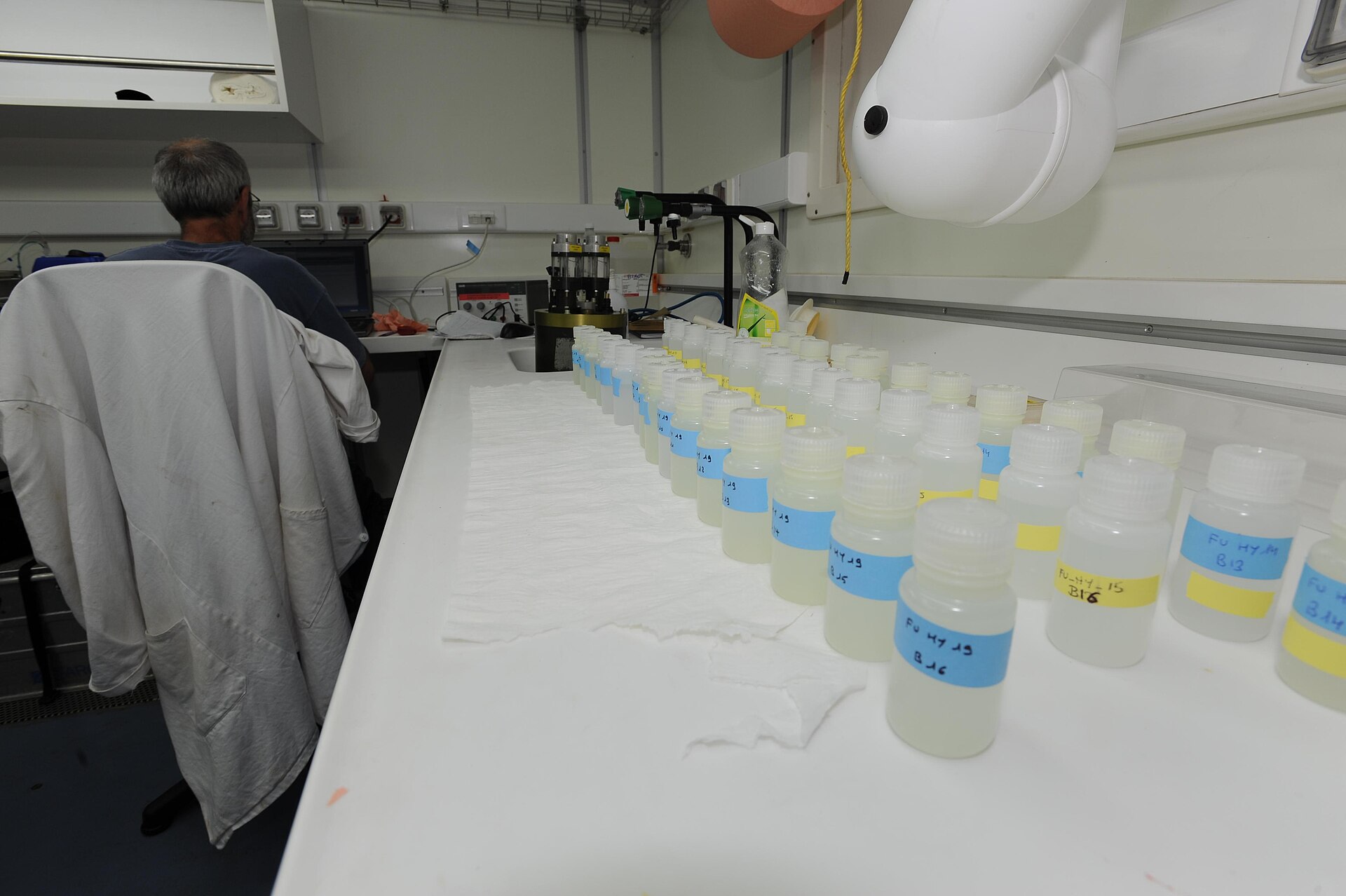 Rows of labeled water sample bottles on a laboratory bench