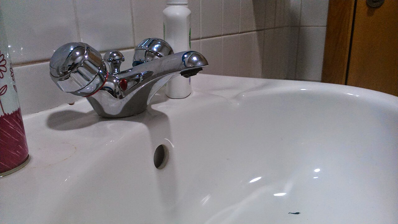 A chrome mixer tap over a white sink