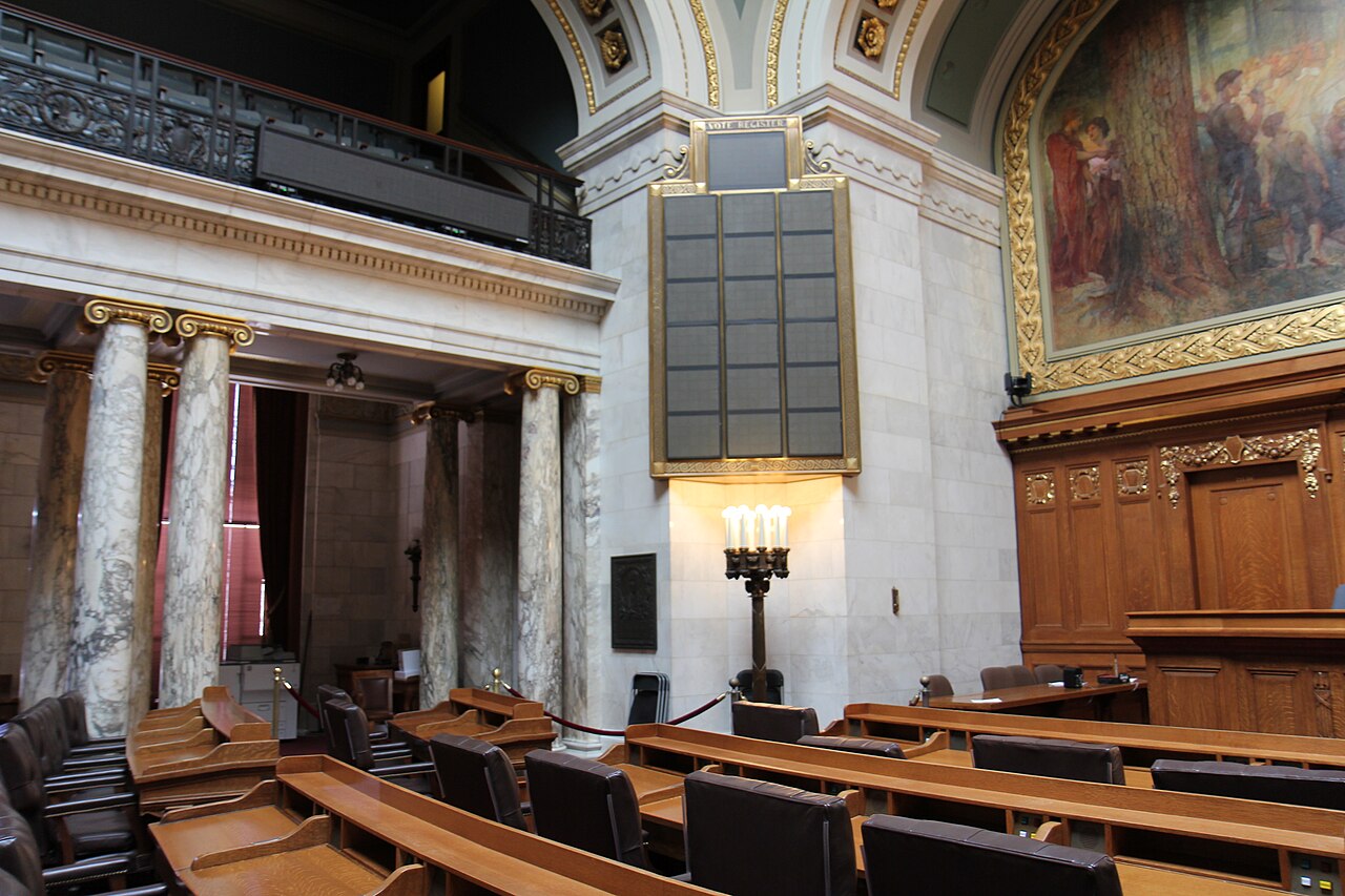 Desks and the electronic vote board in the Wisconsin State Assembly chamber